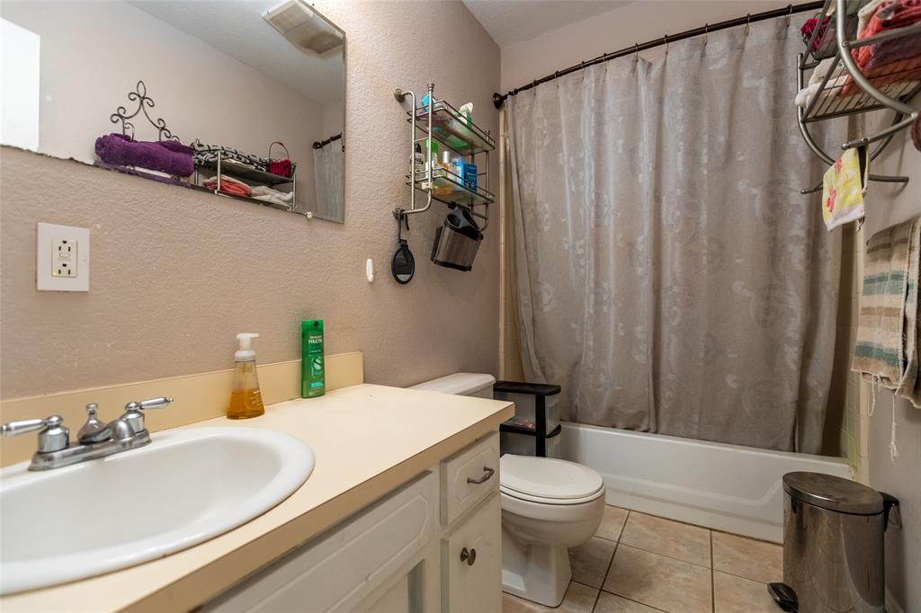2401 West Bethesda Road Burleson, TX 76028 - Photo 11 of 12 a bathroom with a sink vanity mirror and toilet