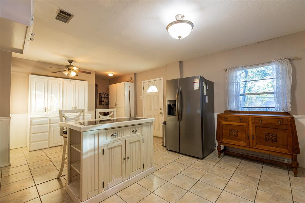 2401 West Bethesda Road Burleson, TX 76028 - Photo 8 of 12 a kitchen with a refrigerator and a stove