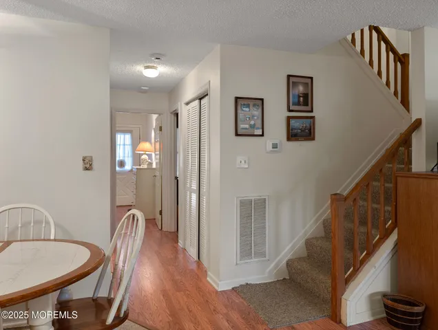 a view of a hallway with furniture and wooden floor