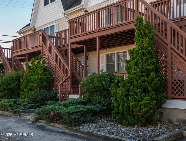 a front view of a house with plants