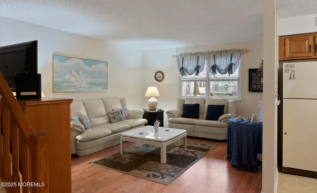 a living room with furniture a lamp and a flat screen tv