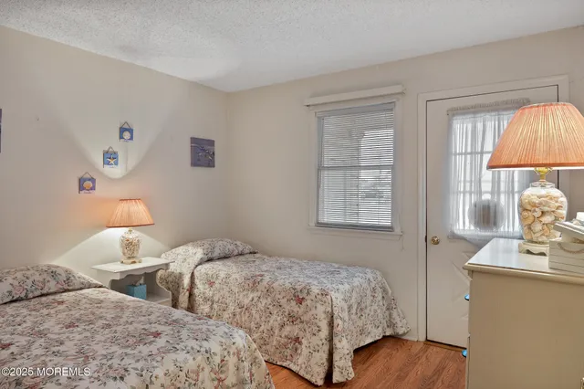 a bedroom with two beds and a window