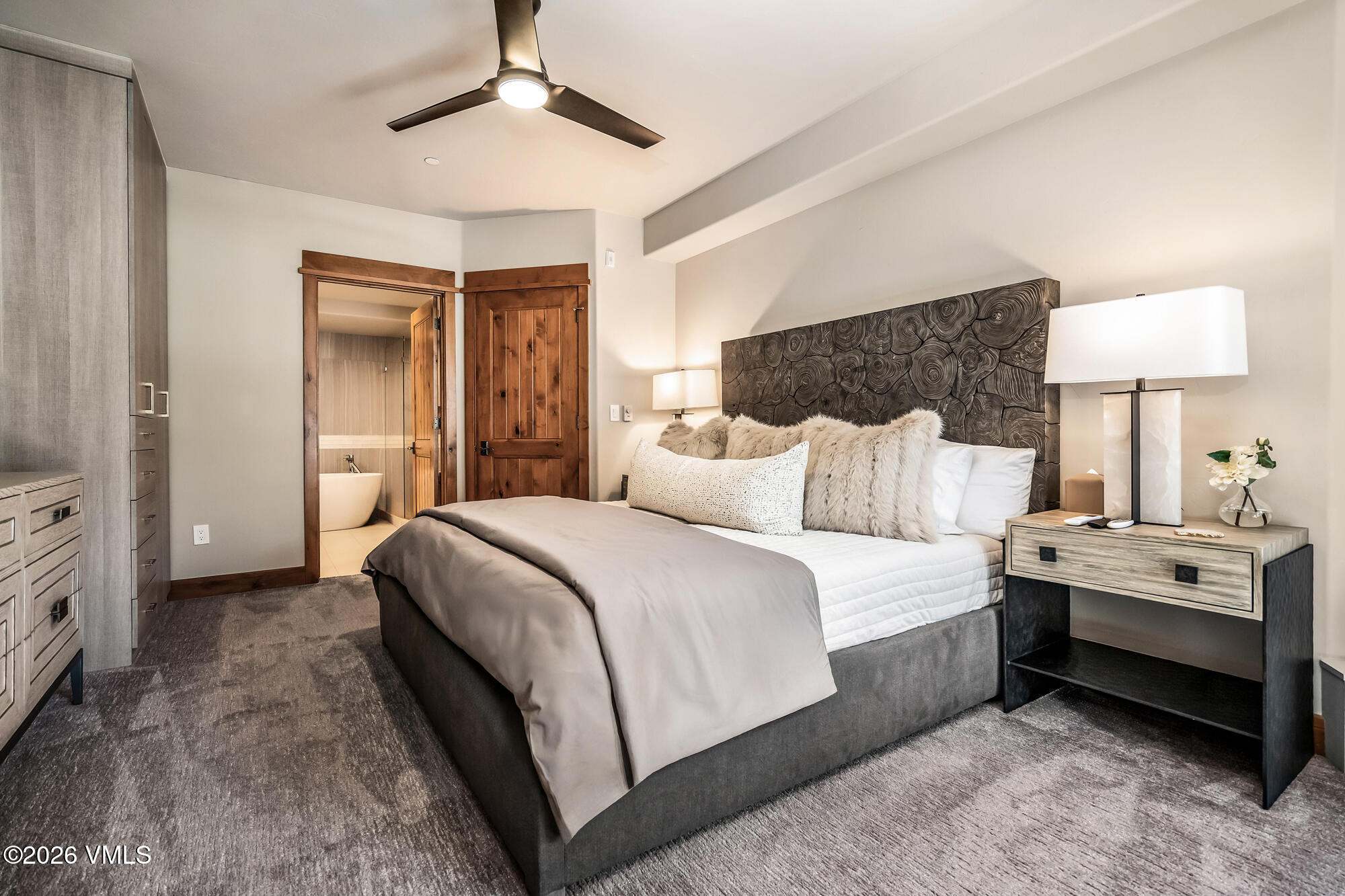 1087 Bachelor Ridge Road, Unit 205 Avon, CO 81620 - Photo 14 of 46 a spacious bedroom with a bed and a lamp