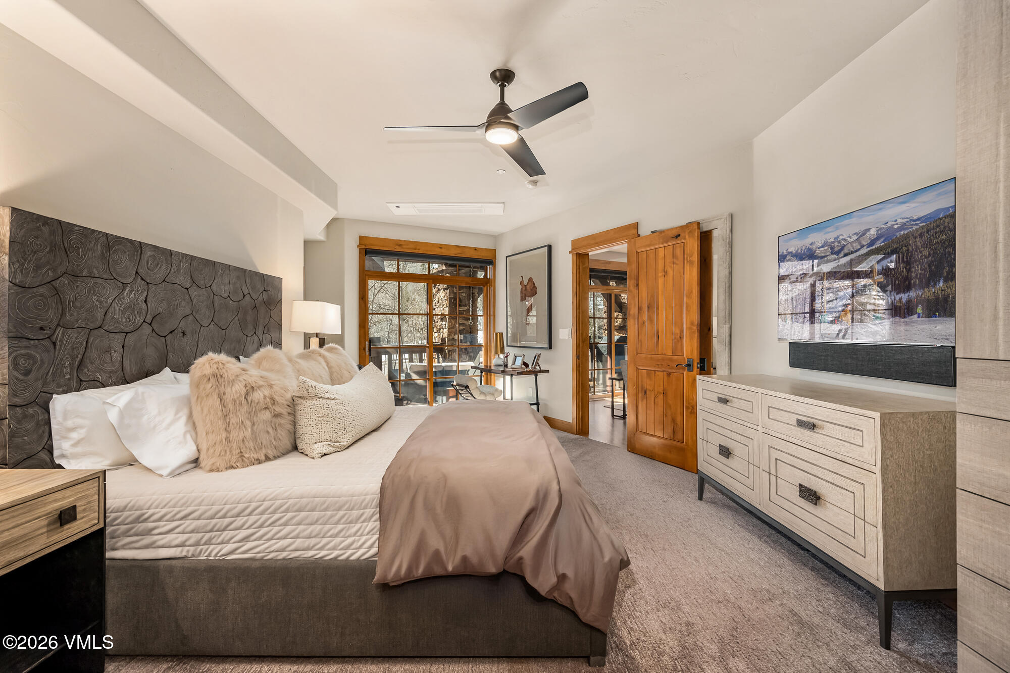 1087 Bachelor Ridge Road, Unit 205 Avon, CO 81620 - Photo 15 of 46 a bedroom with a large bed and a flat tv screen