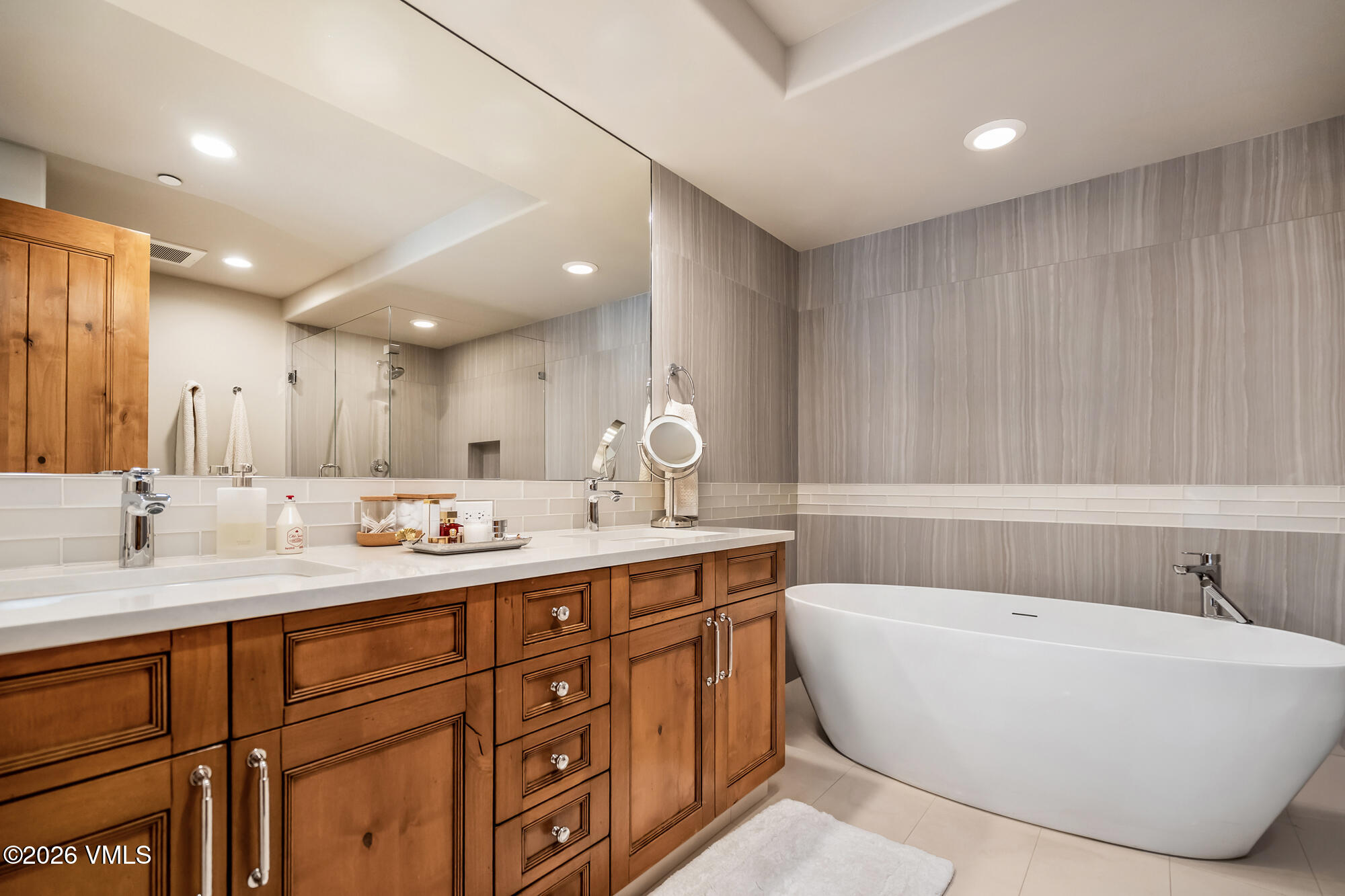 1087 Bachelor Ridge Road, Unit 205 Avon, CO 81620 - Photo 18 of 45 a bathroom with a tub sink and mirror