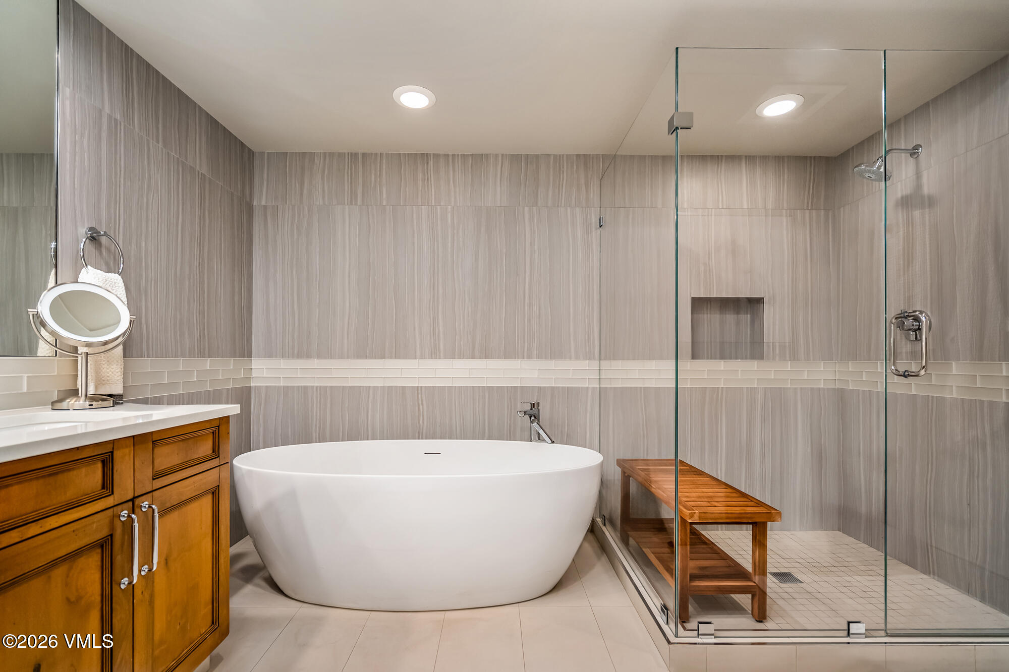 1087 Bachelor Ridge Road, Unit 205 Avon, CO 81620 - Photo 20 of 45 a bathroom with a bathtub a sink and a mirror