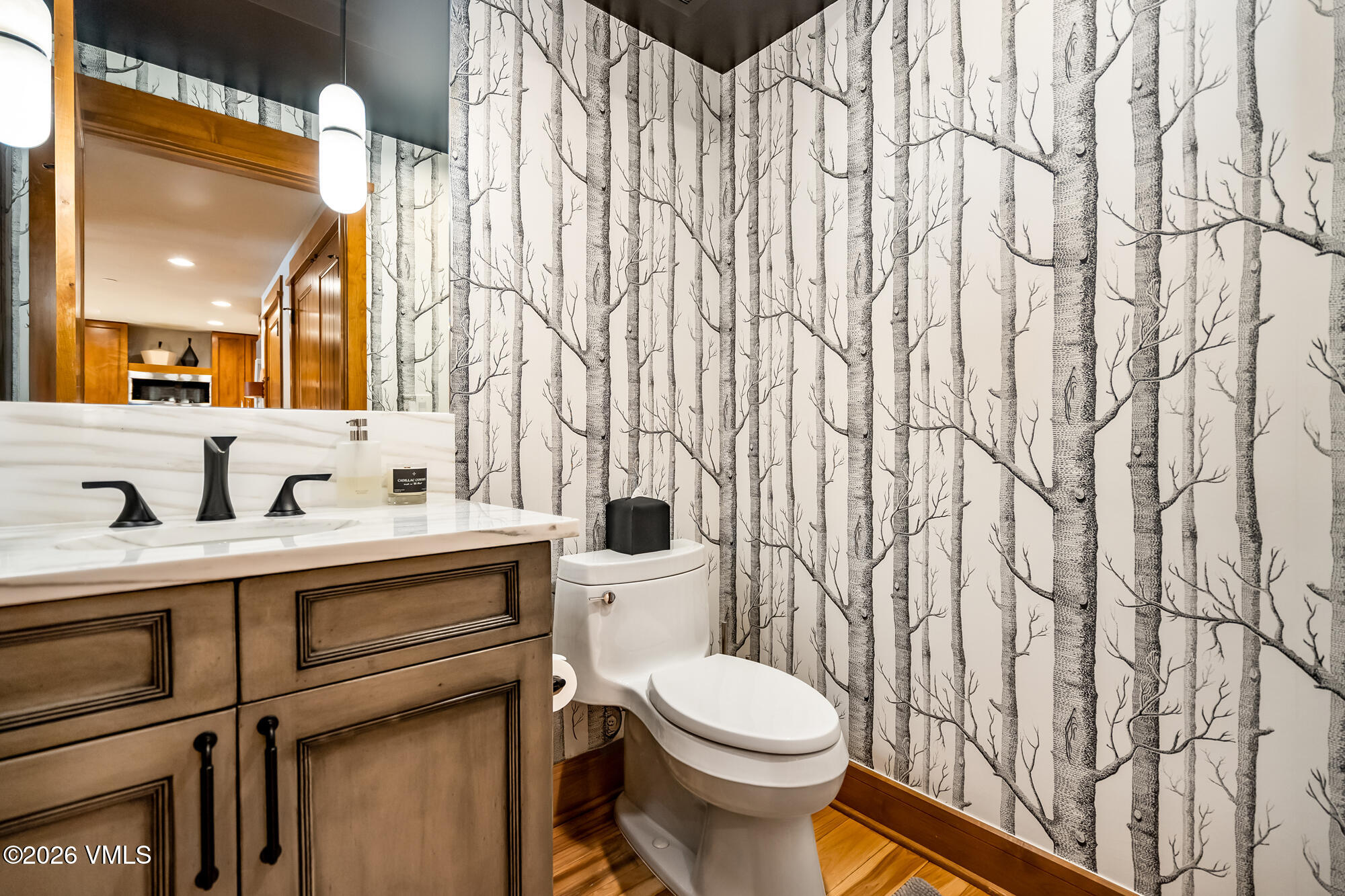 1087 Bachelor Ridge Road, Unit 205 Avon, CO 81620 - Photo 22 of 45 a bathroom with a toilet a sink and a mirror