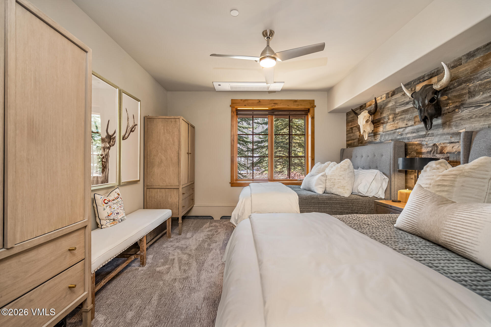 1087 Bachelor Ridge Road, Unit 205 Avon, CO 81620 - Photo 23 of 45 a spacious bedroom with a bed a window and ceiling fan