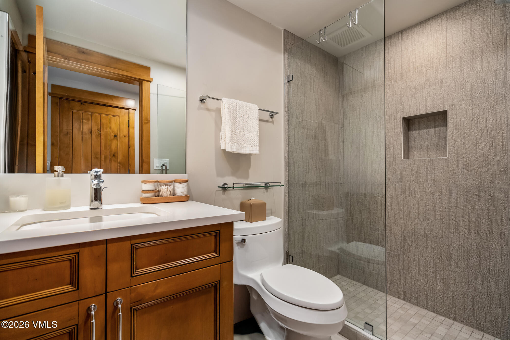 1087 Bachelor Ridge Road, Unit 205 Avon, CO 81620 - Photo 25 of 46 a bathroom with a toilet a sink a mirror and shower