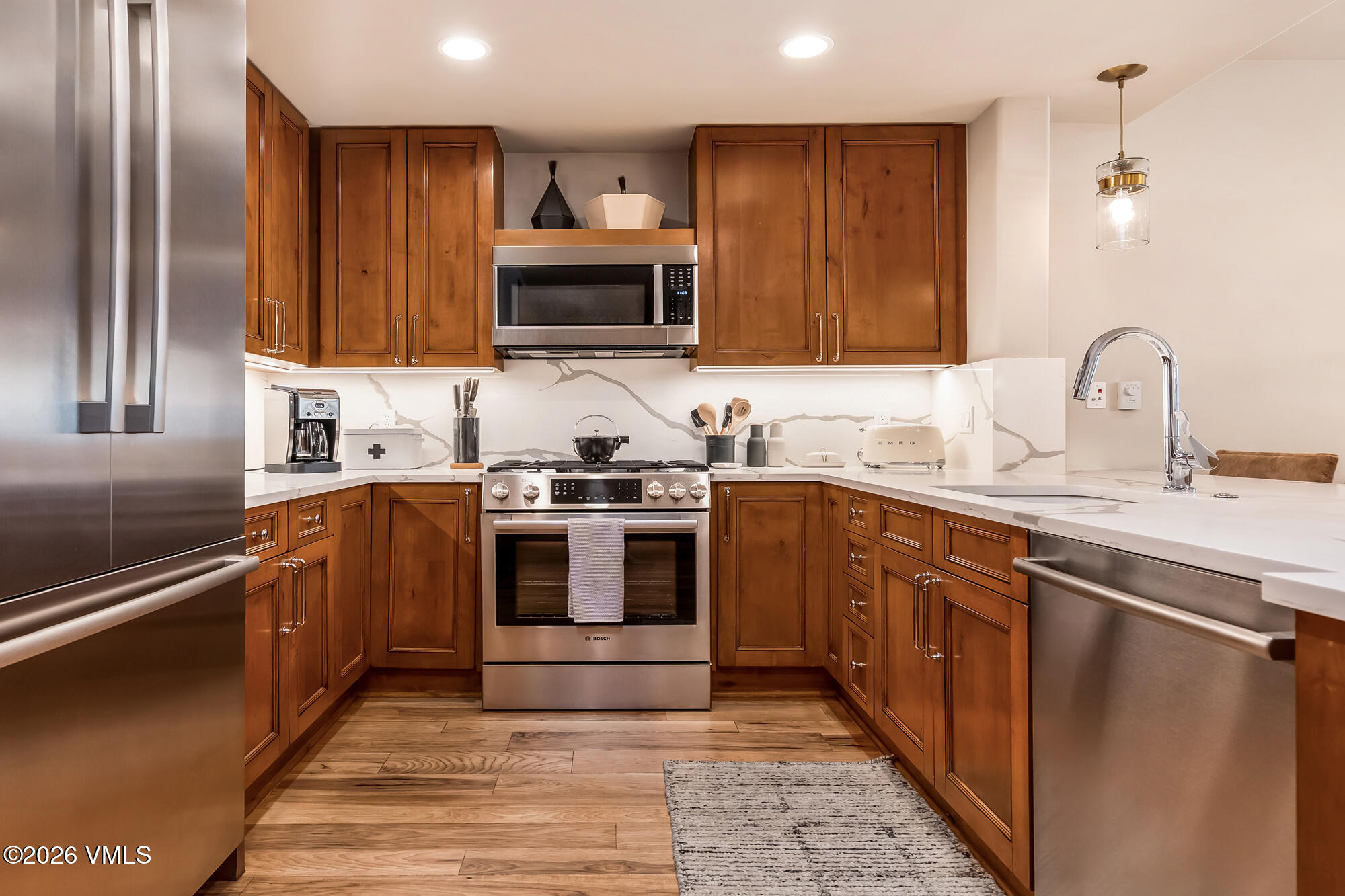 1087 Bachelor Ridge Road, Unit 205 Avon, CO 81620 - Photo 26 of 46 a kitchen with stainless steel appliances granite countertop a sink stove and microwave