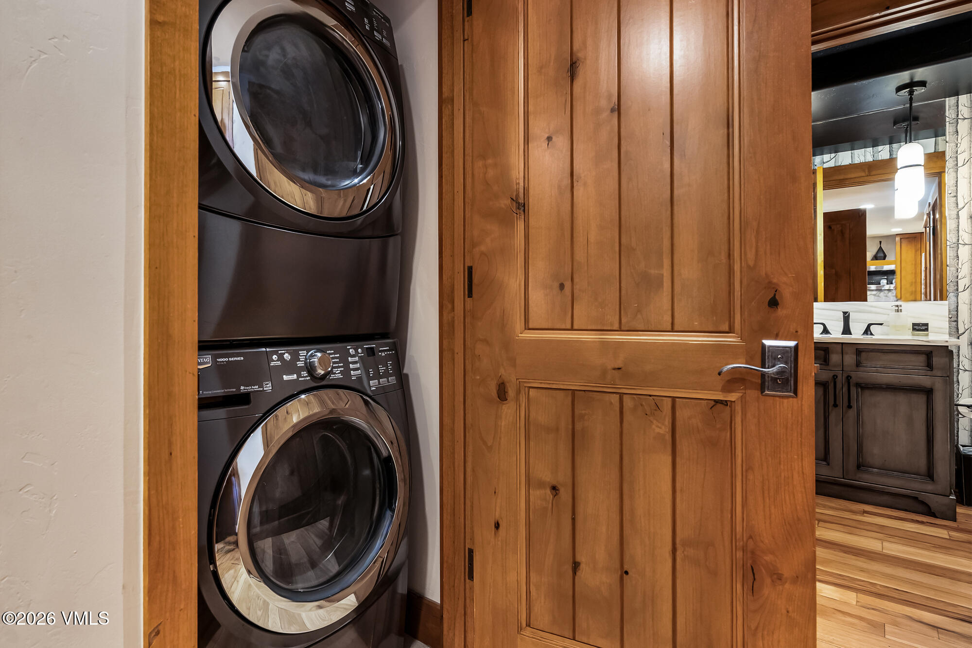 1087 Bachelor Ridge Road, Unit 205 Avon, CO 81620 - Photo 27 of 46 a view of a bedroom with washer and dryer