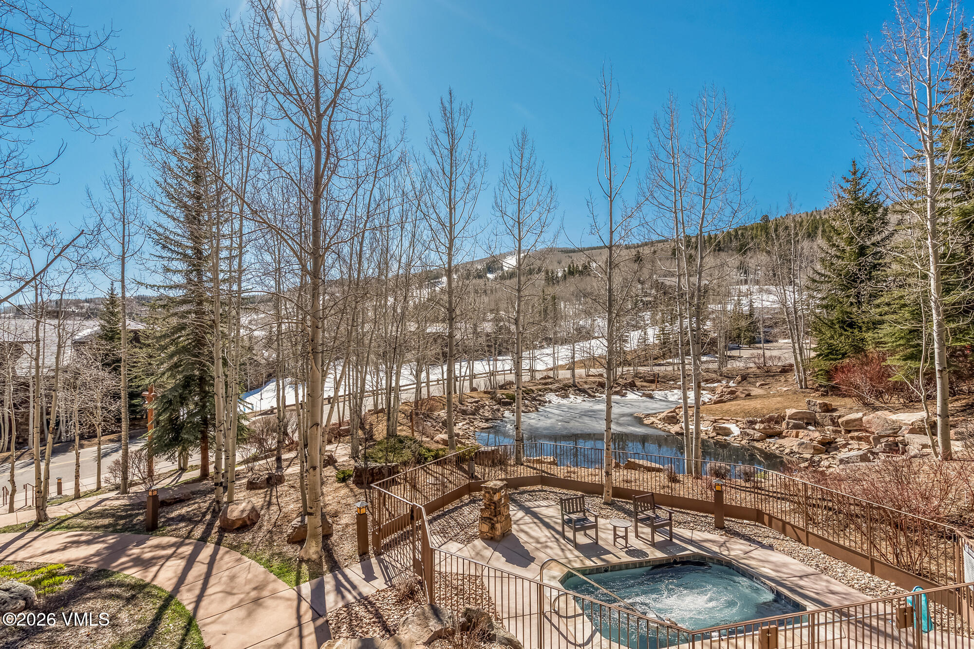 1087 Bachelor Ridge Road, Unit 205 Avon, CO 81620 - Photo 29 of 46 a view of a backyard with a chair and table in the patio