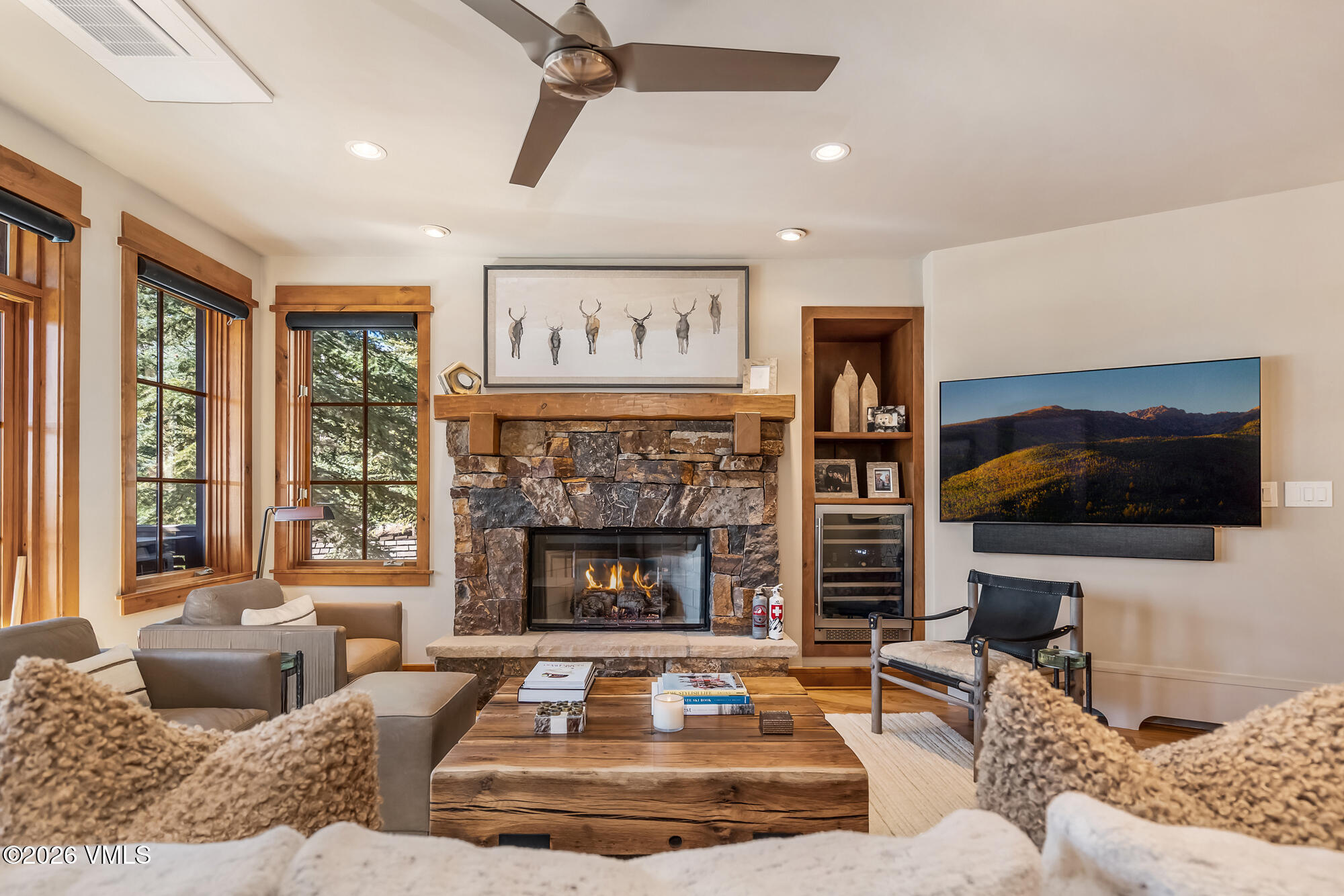 1087 Bachelor Ridge Road, Unit 205 Avon, CO 81620 - Photo 5 of 45 a living room with furniture a flat screen tv and a fireplace