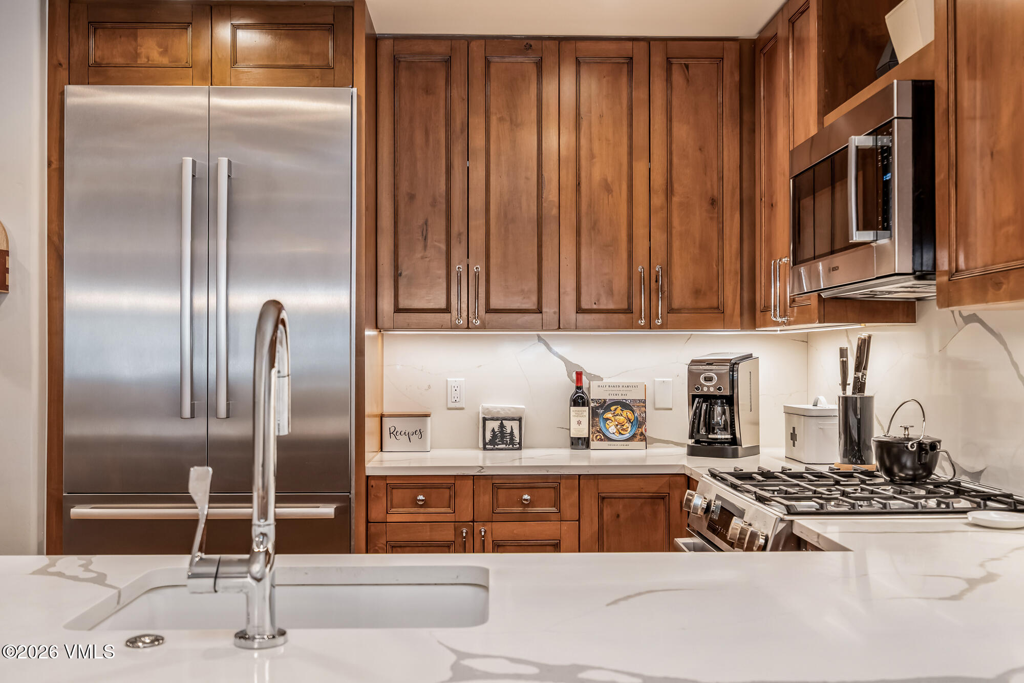 1087 Bachelor Ridge Road, Unit 205 Avon, CO 81620 - Photo 7 of 46 a kitchen with stainless steel appliances granite countertop a refrigerator and a stove top oven
