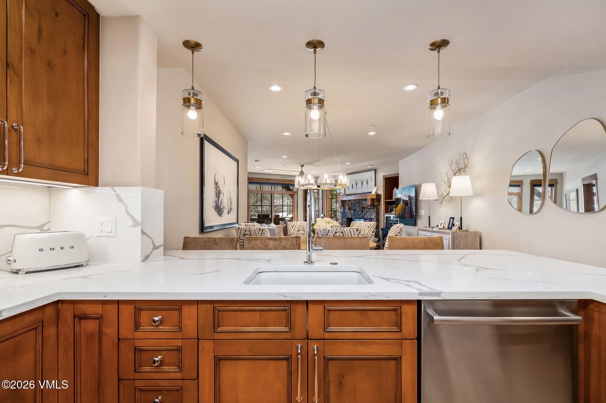 1087 Bachelor Ridge Road, Unit 205 Avon, CO 81620 - Photo 10 of 46 a kitchen with kitchen island granite countertop a sink and center island