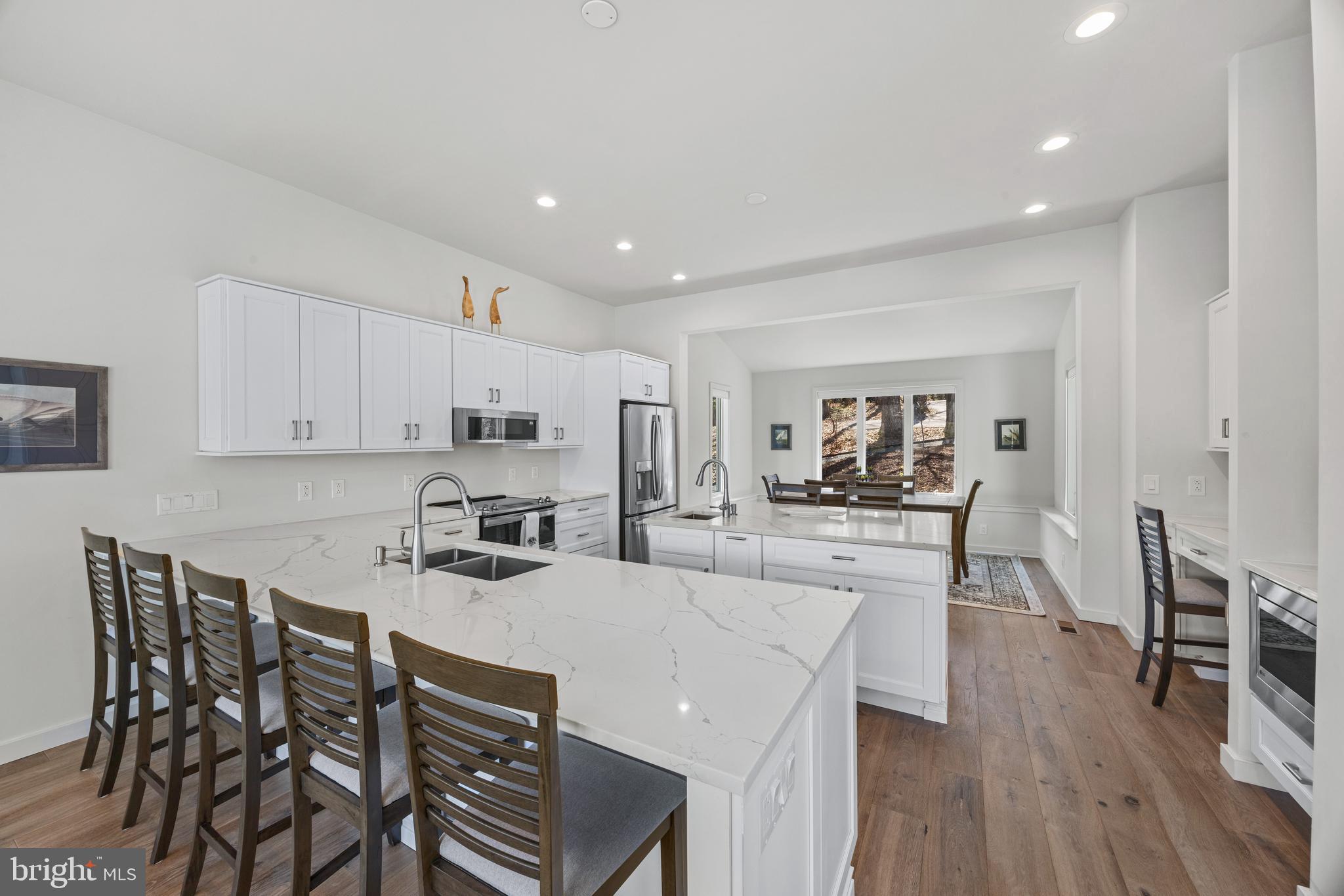 378 Forest Beach Road Annapolis, MD 21409 - Photo 13 of 42 a kitchen with stainless steel appliances a table and chairs in it