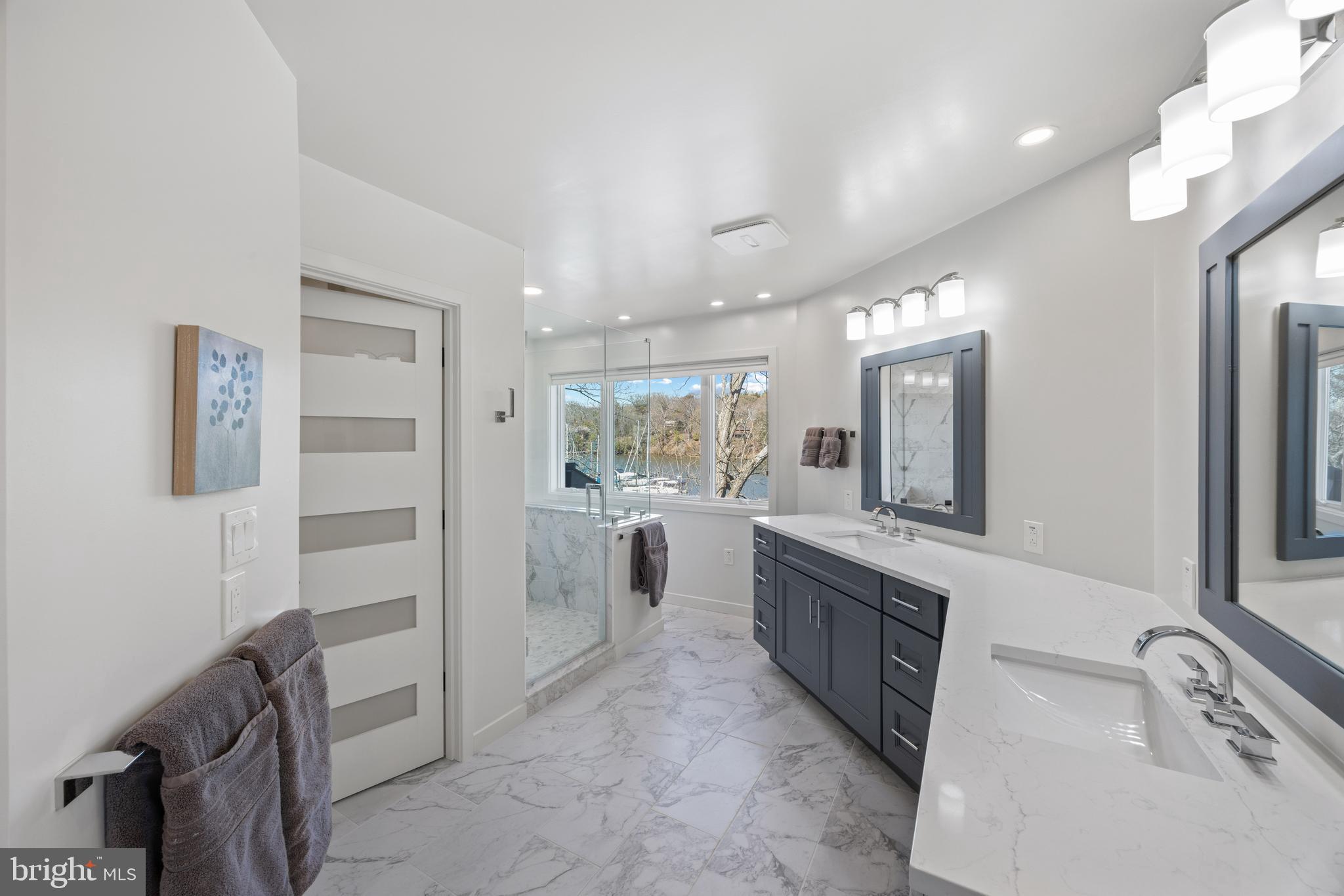 378 Forest Beach Road Annapolis, MD 21409 - Photo 25 of 42 a large white bathroom with a granite countertop sink mirror and bathtub