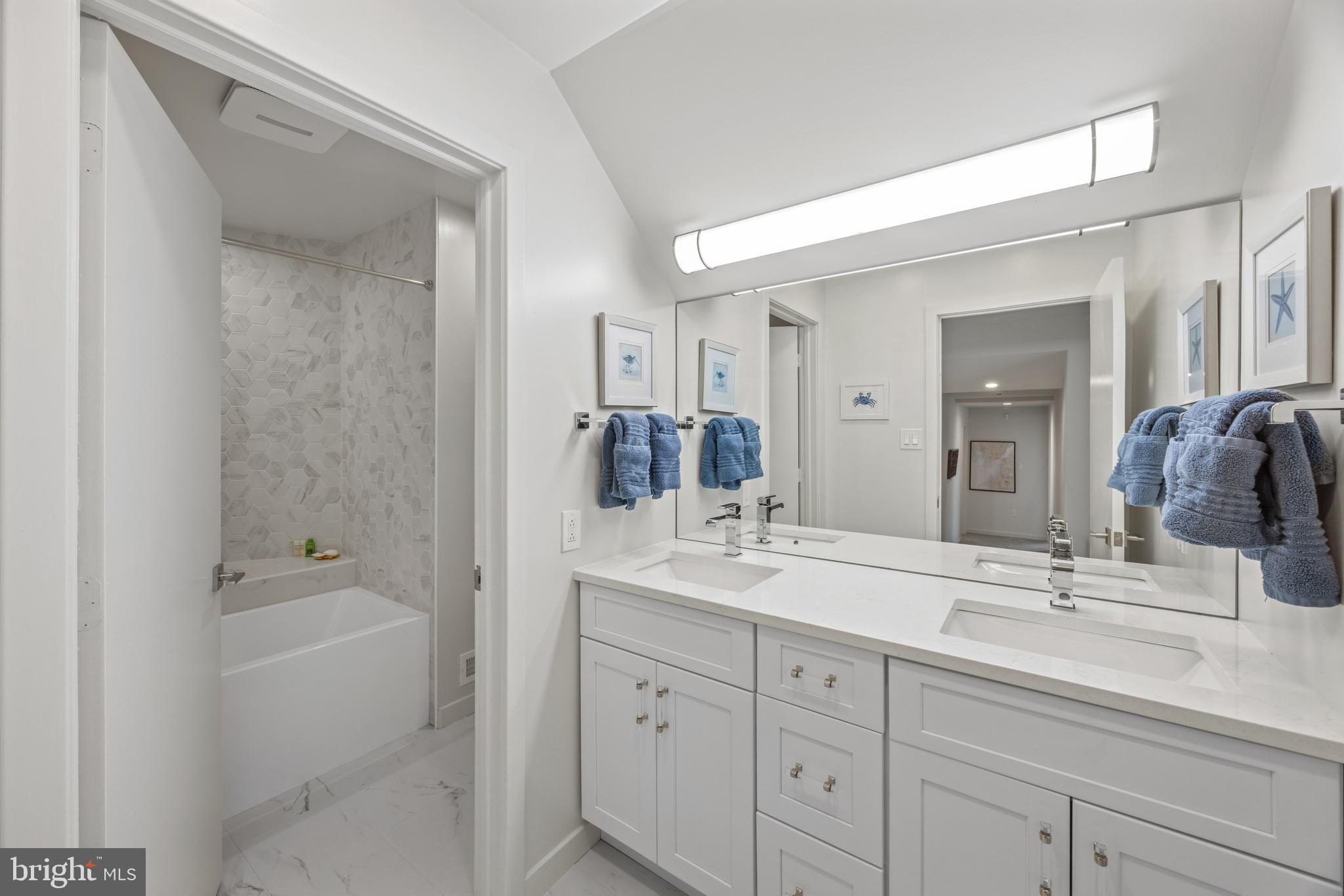 378 Forest Beach Road Annapolis, MD 21409 - Photo 31 of 42 a bathroom with a double vanity sink mirror and bathtub