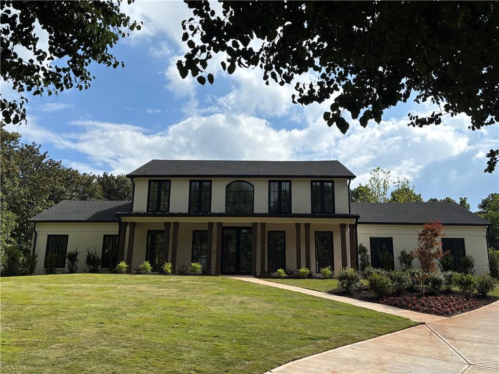 a front view of a house with a garden