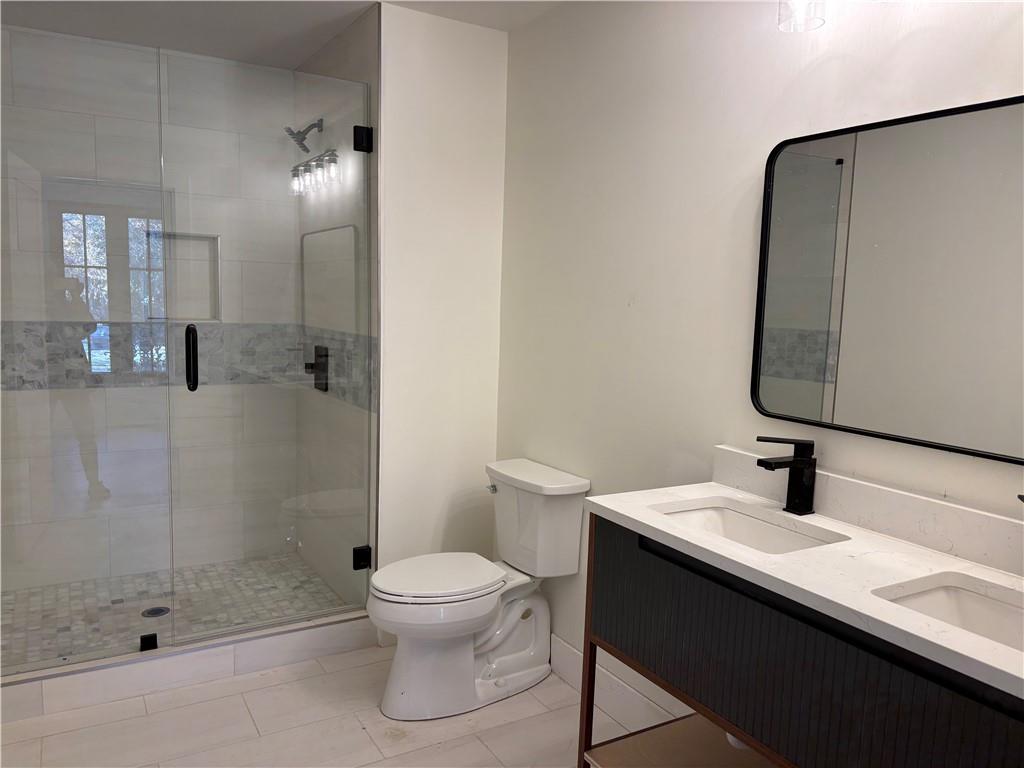 680 Brookfield Parkway Roswell, GA 30075 - Photo 11 of 15 a bathroom with a sink a toilet and shower