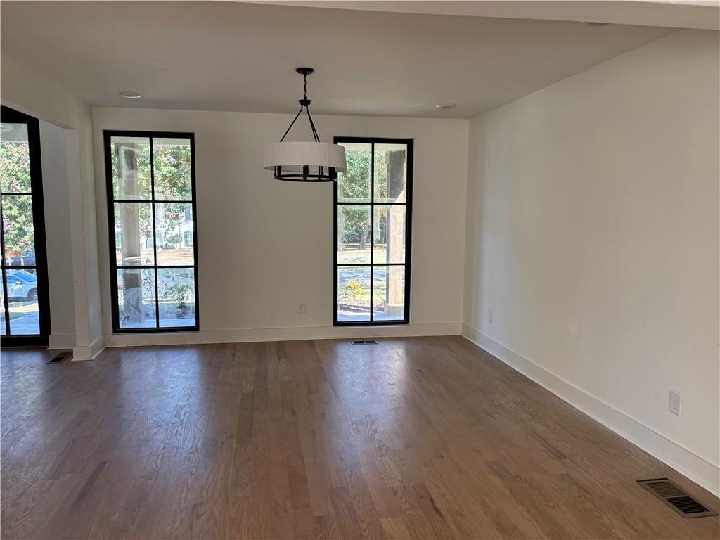 680 Brookfield Parkway Roswell, GA 30075 - Photo 4 of 15 a view of an empty room with wooden floor and a window