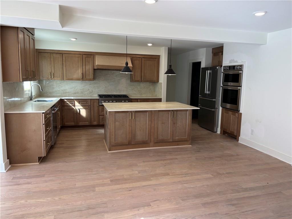 680 Brookfield Parkway Roswell, GA 30075 - Photo 6 of 15 a kitchen with stainless steel appliances granite countertop a sink stove and refrigerator