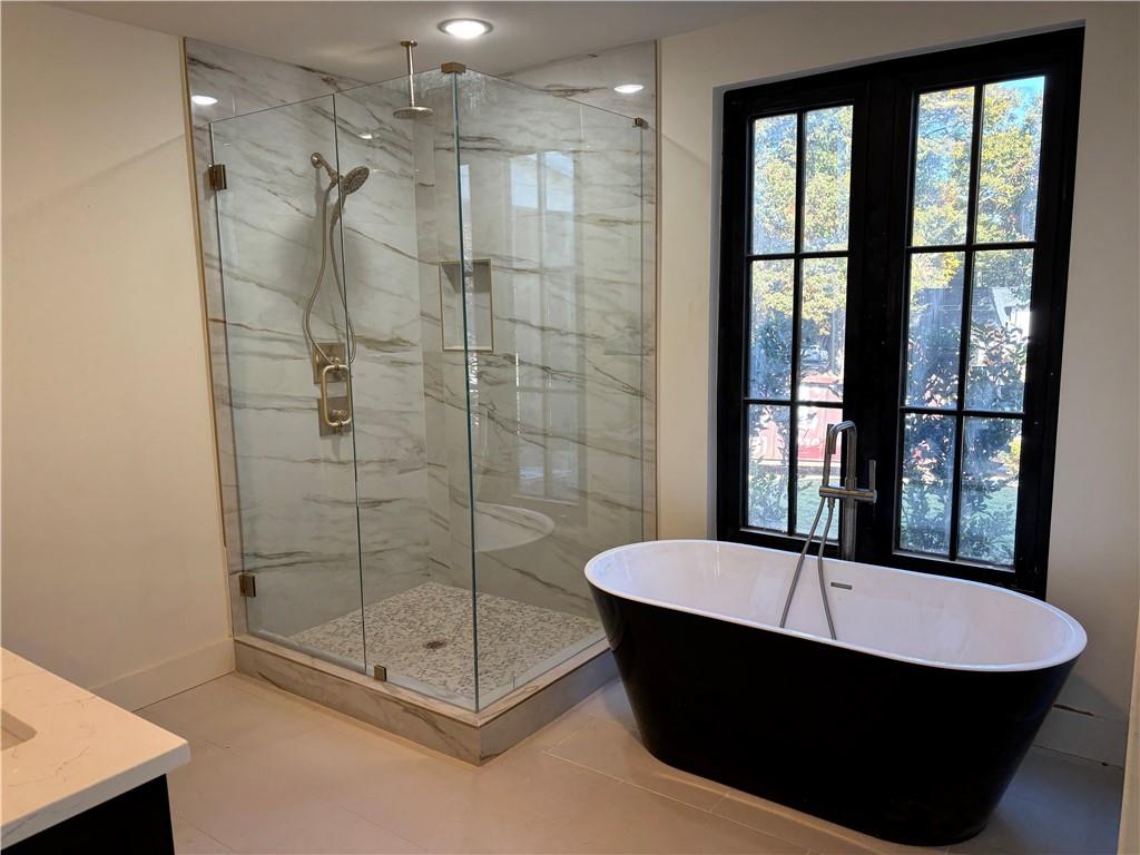 680 Brookfield Parkway Roswell, GA 30075 - Photo 9 of 15 a bathroom with a tub and shower