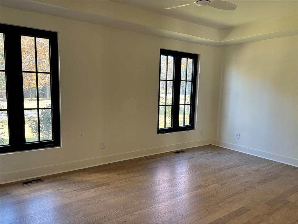 680 Brookfield Parkway Roswell, GA 30075 - Photo 10 of 15 an empty room with wooden floor and windows