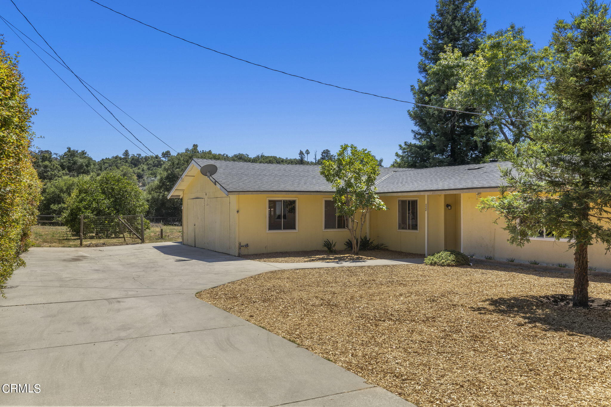 320 Cruzero Street Ojai, CA 93023 - Photo 2 of 48 a front view of a house with a yard and garage