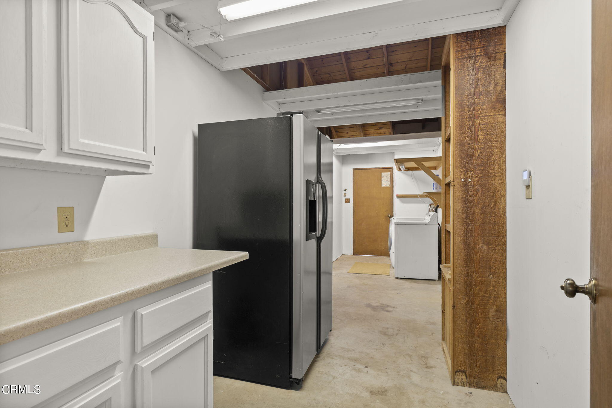 320 Cruzero Street Ojai, CA 93023 - Photo 27 of 48 a kitchen with a refrigerator and cabinets