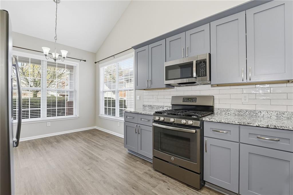 1527 Anna Ruby Lane Kennesaw, GA 30152 - Photo 11 of 42 a kitchen with stainless steel appliances granite countertop a stove and a microwave