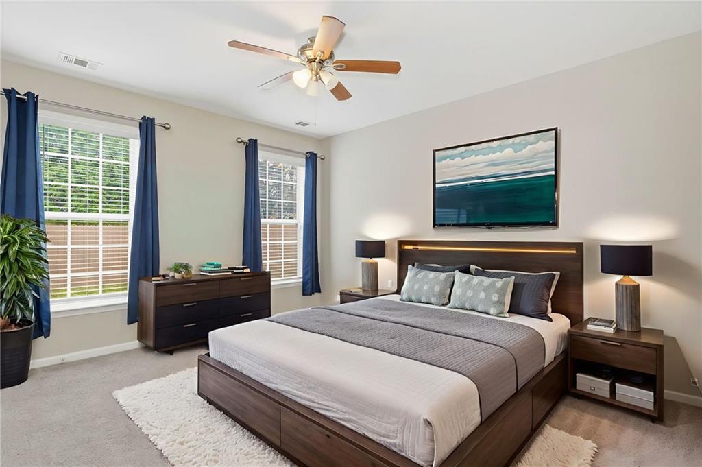 1527 Anna Ruby Lane Kennesaw, GA 30152 - Photo 23 of 42 a bedroom with a bed and a chandelier