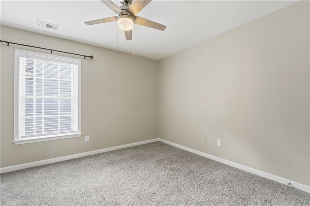1527 Anna Ruby Lane Kennesaw, GA 30152 - Photo 28 of 42 an empty room with a window and a fan