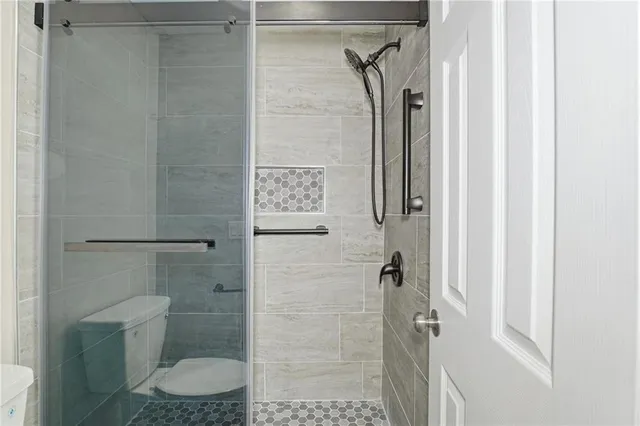 an empty room with windows and ceiling fan