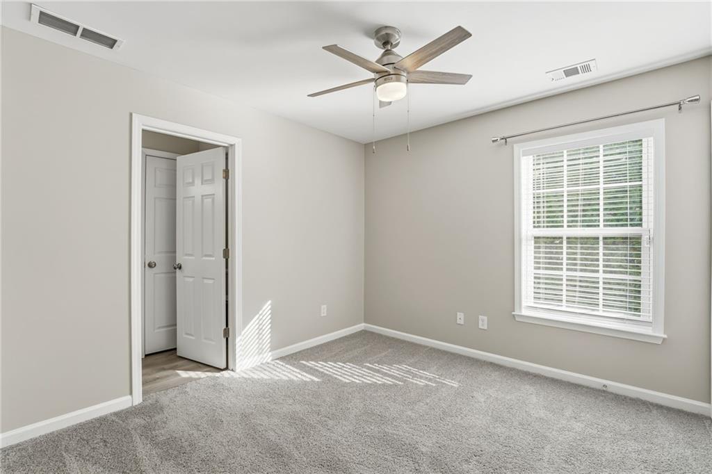 1527 Anna Ruby Lane Kennesaw, GA 30152 - Photo 38 of 42 an empty room with a window and a fan