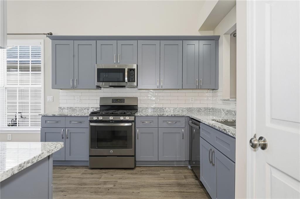 1527 Anna Ruby Lane Kennesaw, GA 30152 - Photo 10 of 42 a kitchen with granite countertop a stove and a sink