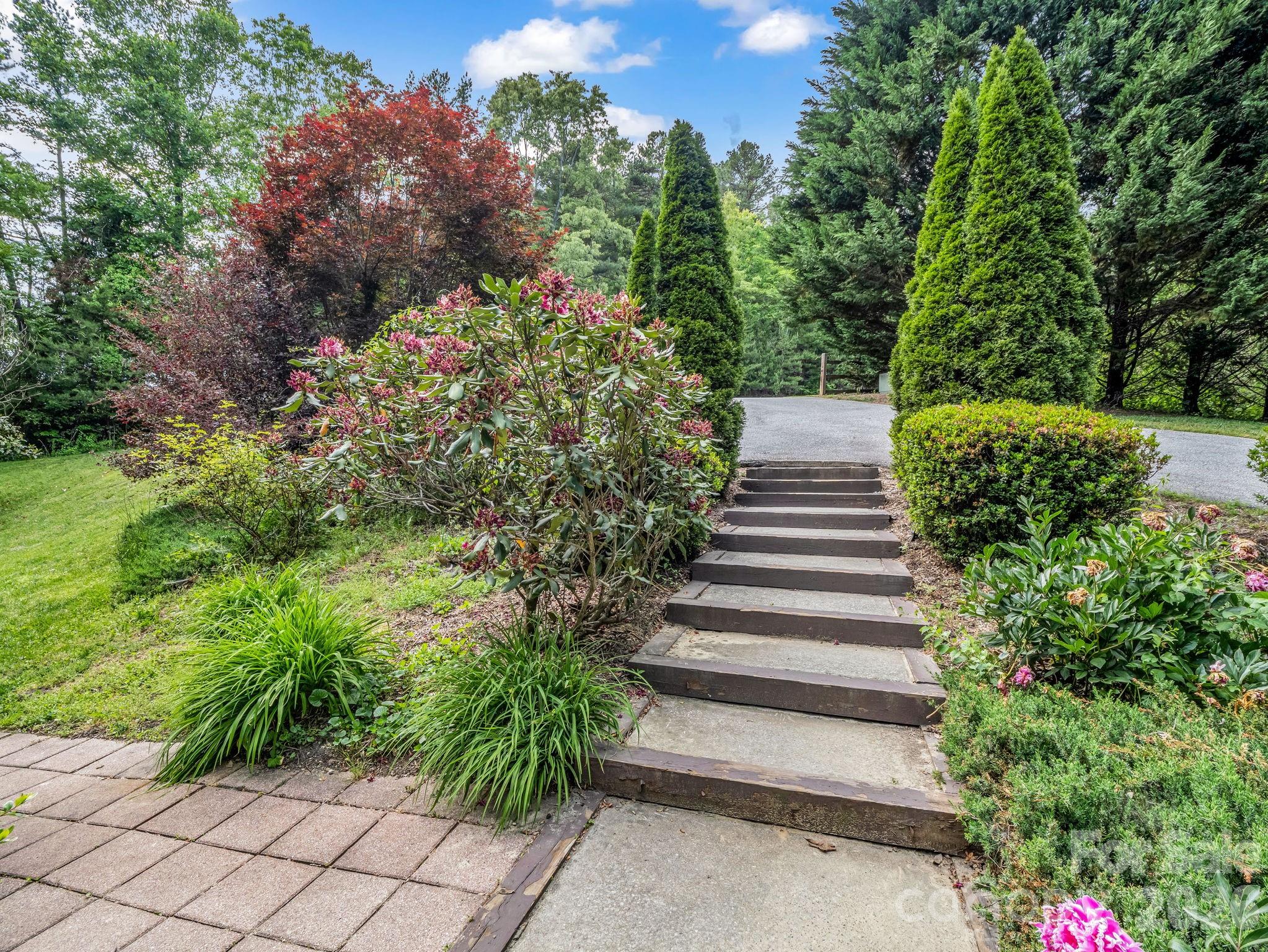 165 Dream Road Hendersonville, NC 28792 - Photo 3 of 46 a view of a garden with flowers