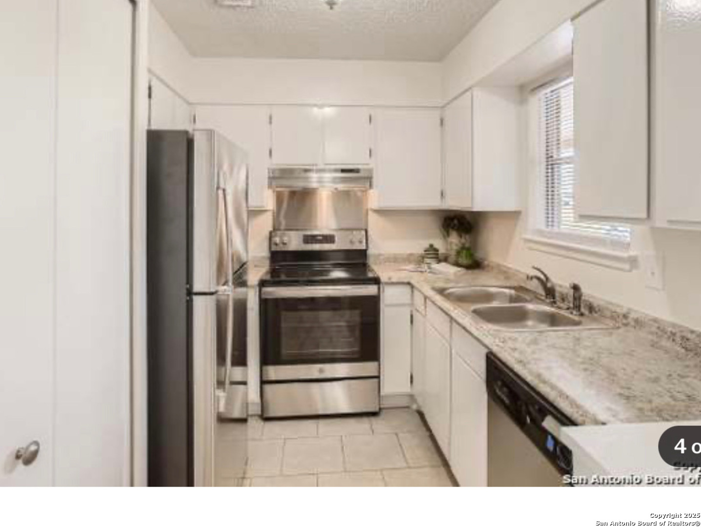 923 Vance Jackson Road, Unit 1210 San Antonio, TX 78201 - Photo 3 of 6 a kitchen with a sink stove and refrigerator