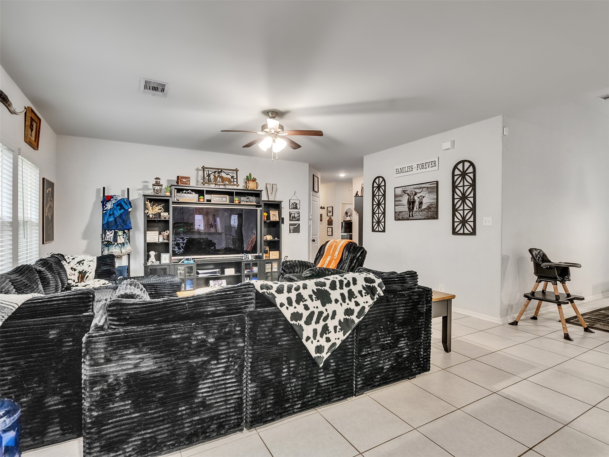 8719 Willet Street Baytown, TX 77521 - Photo 15 of 42 a living room with furniture and a flat screen tv