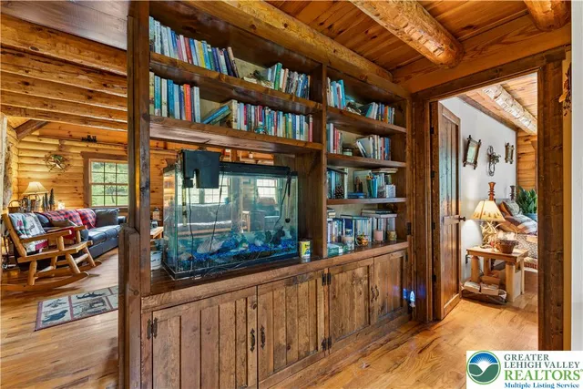 a bedroom with furniture and a large window