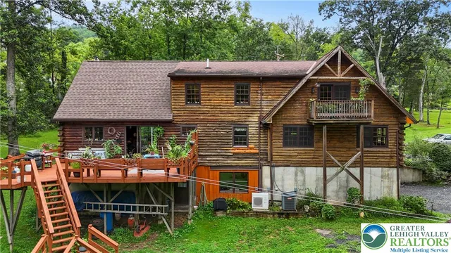 an aerial view of a house with garden space and street view