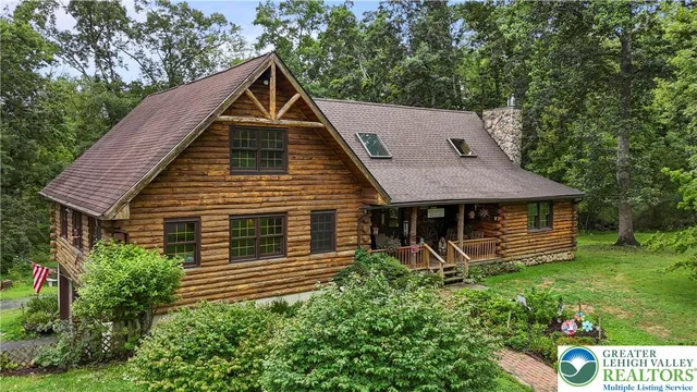 a view of a house with a yard and potted plants