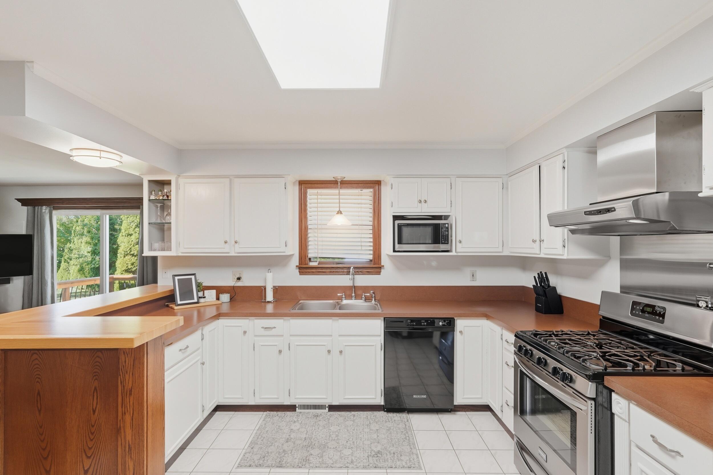 2325 Drop Anchor Drive Crown Point, IN 46307 - Photo 15 of 28 a kitchen with a sink stove top oven and refrigerator