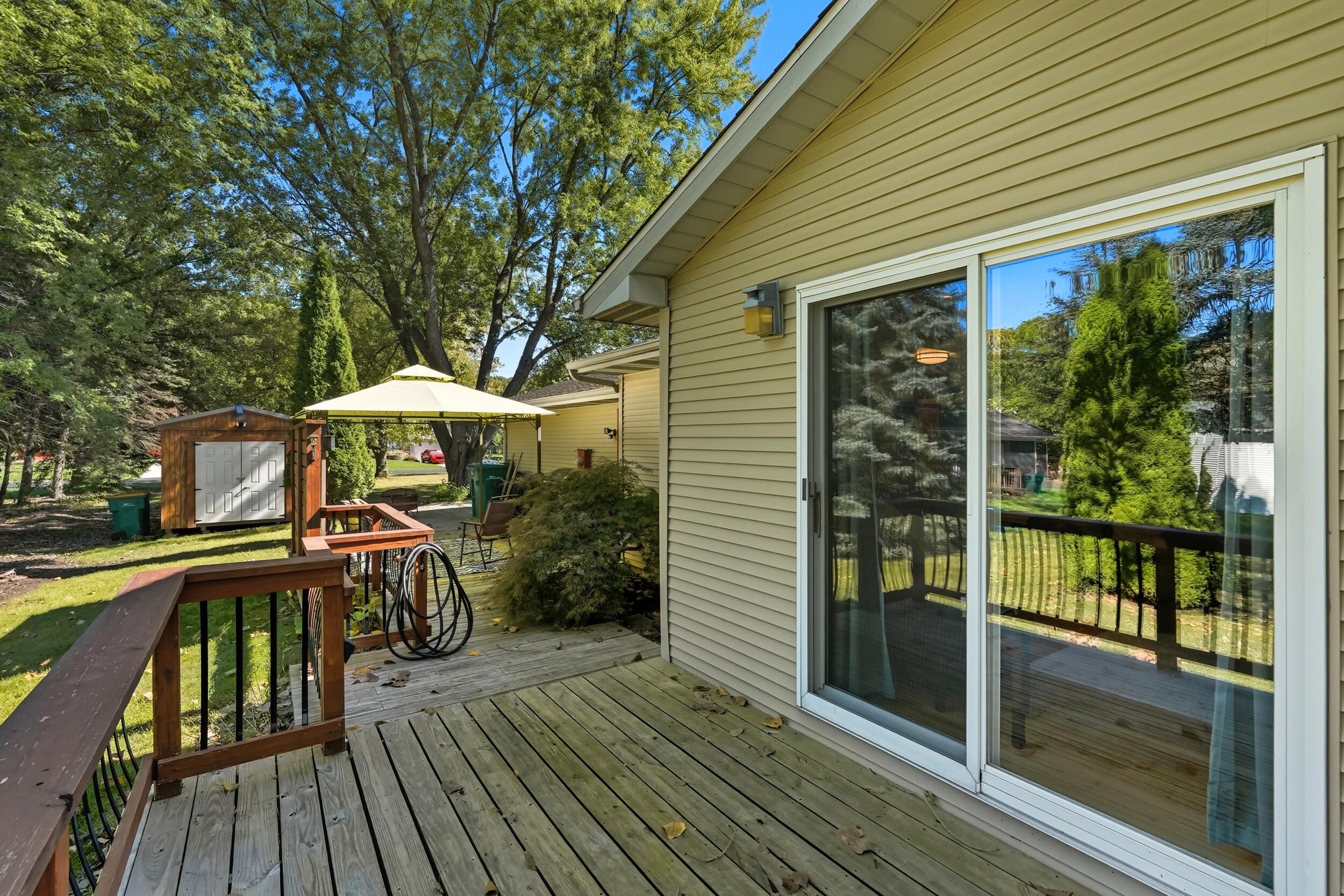 2325 Drop Anchor Drive Crown Point, IN 46307 - Photo 25 of 28 a view of a patio with table and chairs under an umbrella with wooden floor