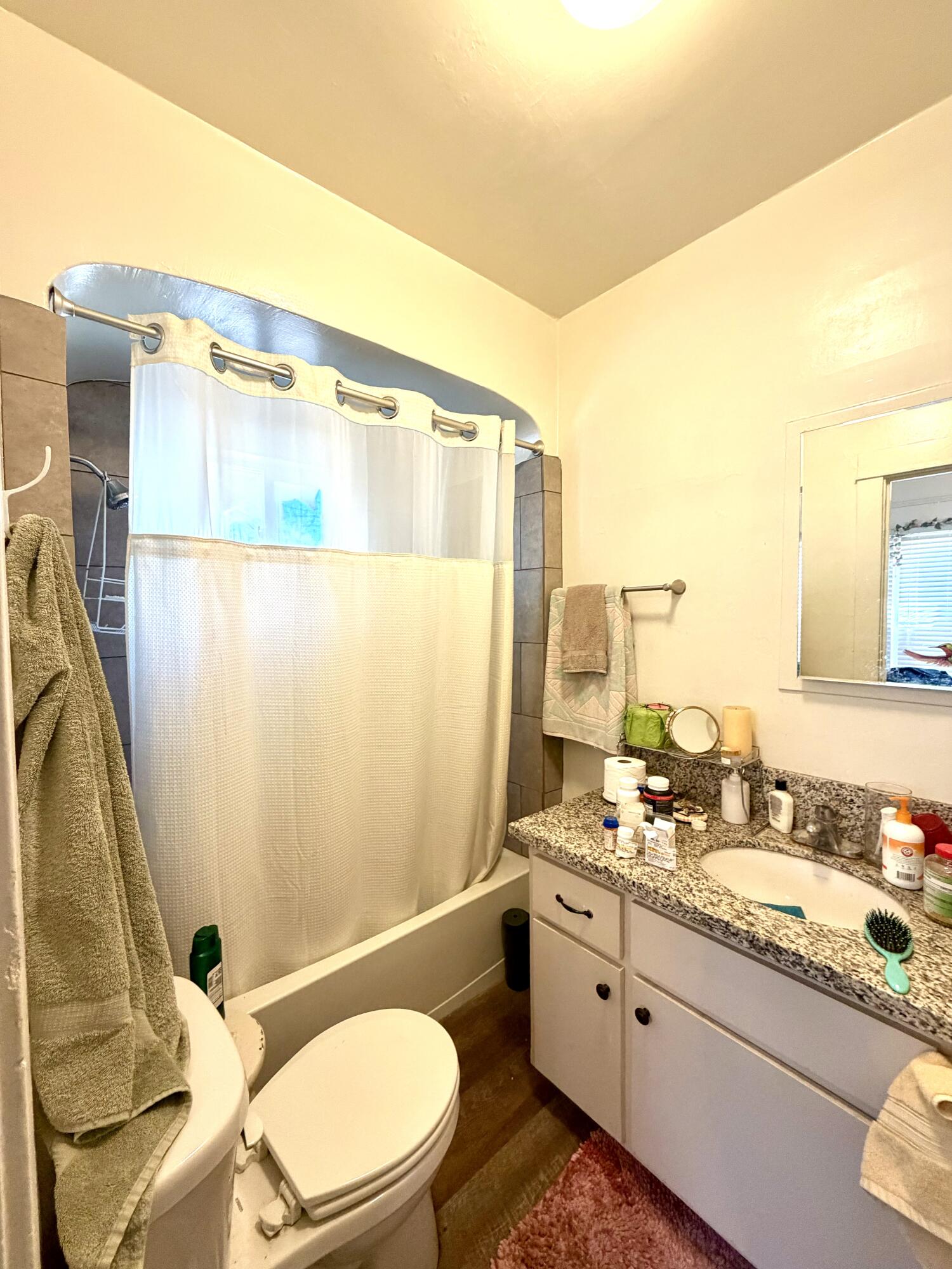 200 North B Street Exeter, CA 93221 - Photo 16 of 20 a bathroom with a granite countertop sink mirror vanity and toilet