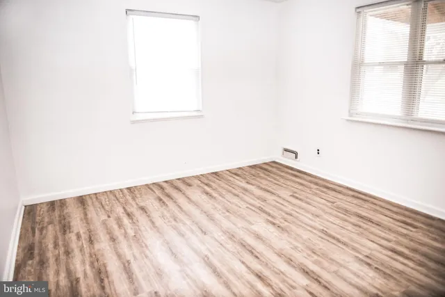 a view of a small space with wooden floor and a window