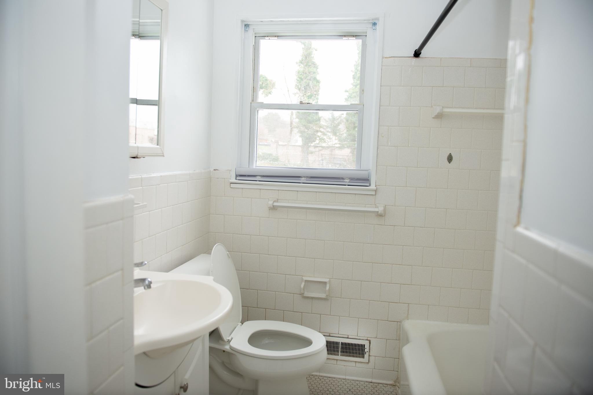 521 Warren Road, Unit 2 Cockeysville, MD 21030 - Photo 16 of 19 a bathroom with a toilet sink and mirror