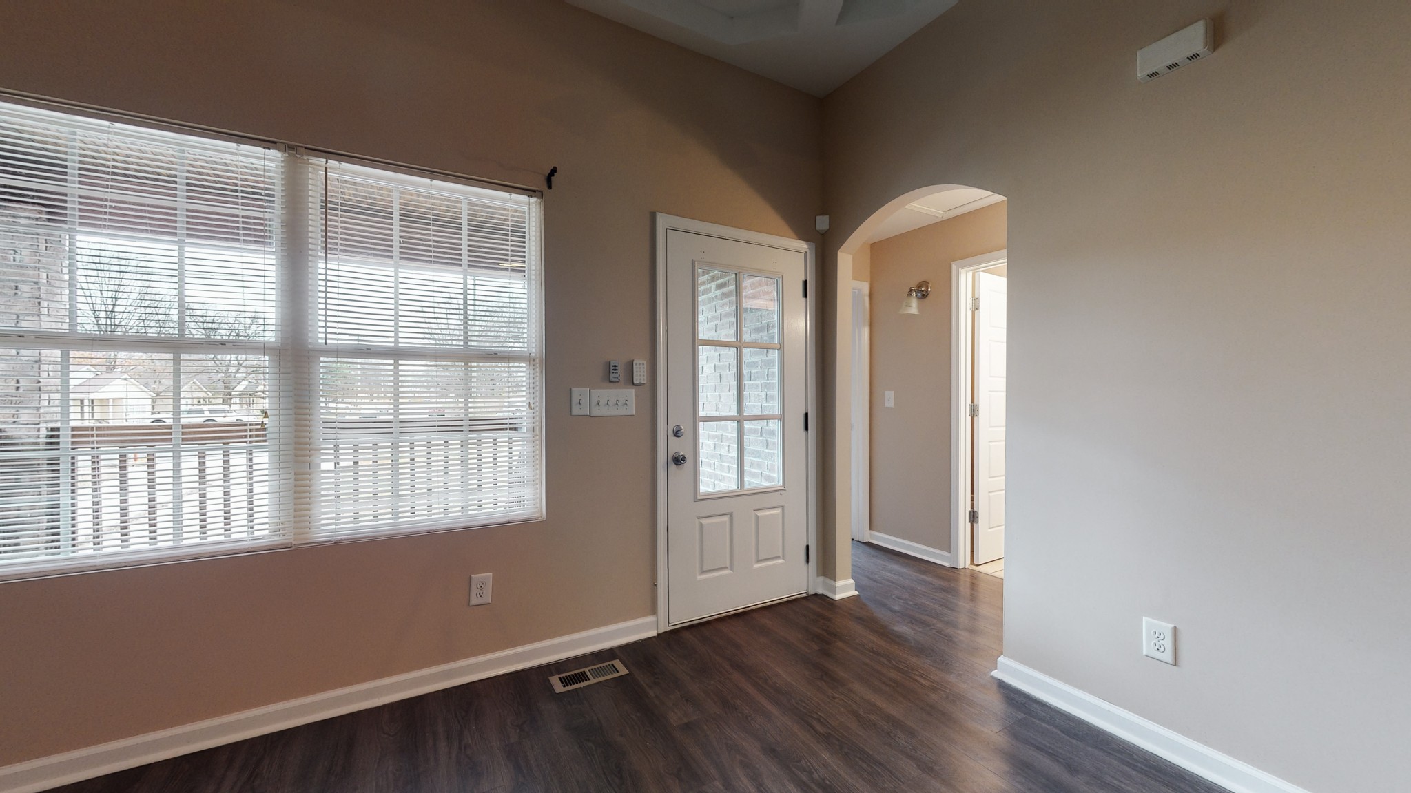 218 Larkin Springs Road Madison, TN 37115 - Photo 2 of 20 an empty room with wooden floor and windows