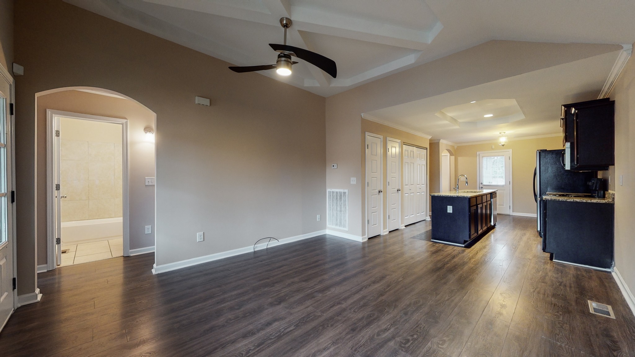 218 Larkin Springs Road Madison, TN 37115 - Photo 3 of 20 an empty room with wooden floor kitchen view and windows