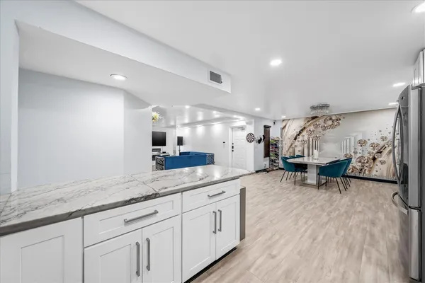 a spacious bathroom with a granite countertop sink a mirror and shower
